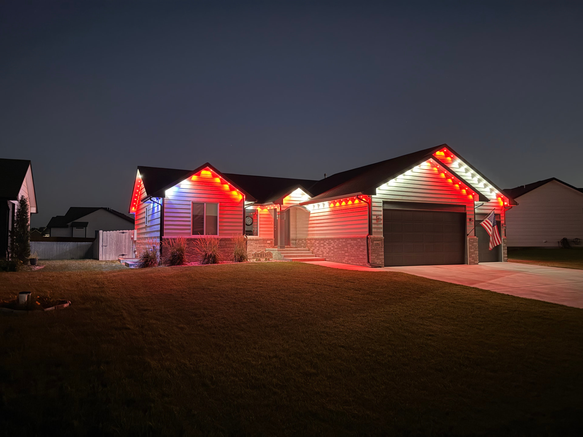 Home lit in red, white and blue permanent LED lights for the holiday